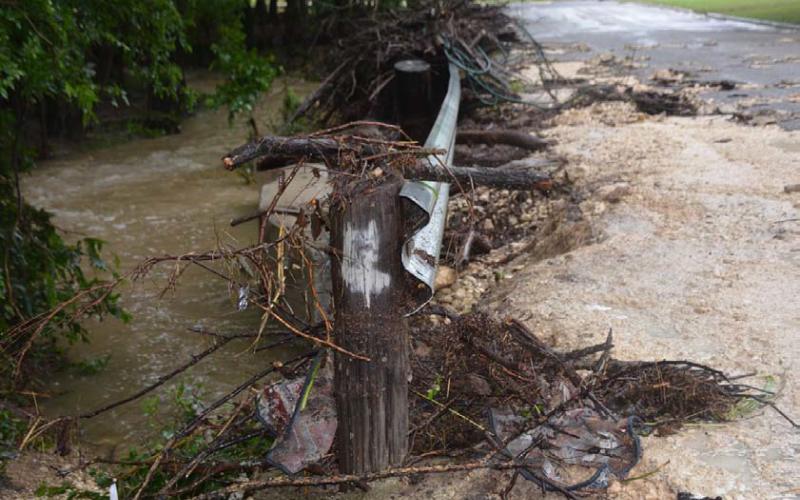 A bridge on East Avenue H sustained damage during Saturday morning’s heavy rains that pummeled the northeast portion of the city. In addition to debris strewn about the guardrail, pavement on the bridge shows significant damage. Water in the creek remained high. JIM LOWE | DISPATCH RECORD