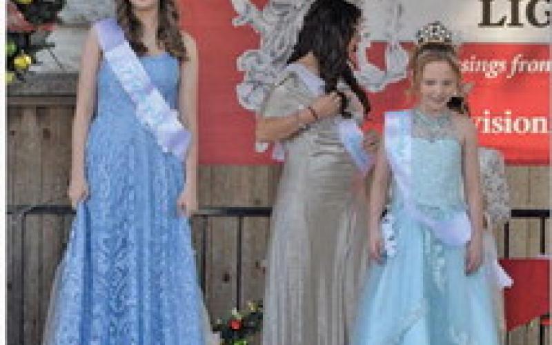 ERICK MITCHELL | DISPATCH RECORD At left, Caroline Claude and Jessi Fields receive their sashes to designate them Snow Princess and Snow Queen, respectively.