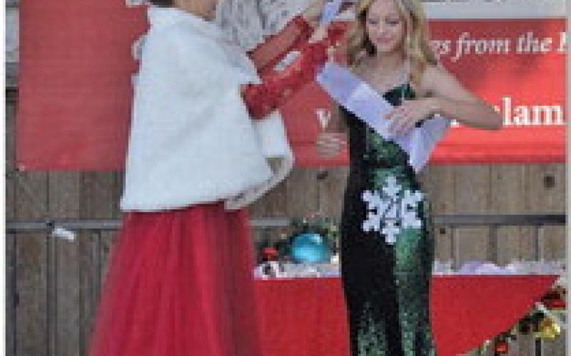 ERICK MITCHELL | DISPATCH RECORD Brynnley Chappell, at right, receives her sash after she garnered the Ambassador Award at Saturday’s Snow Queen Pageant.