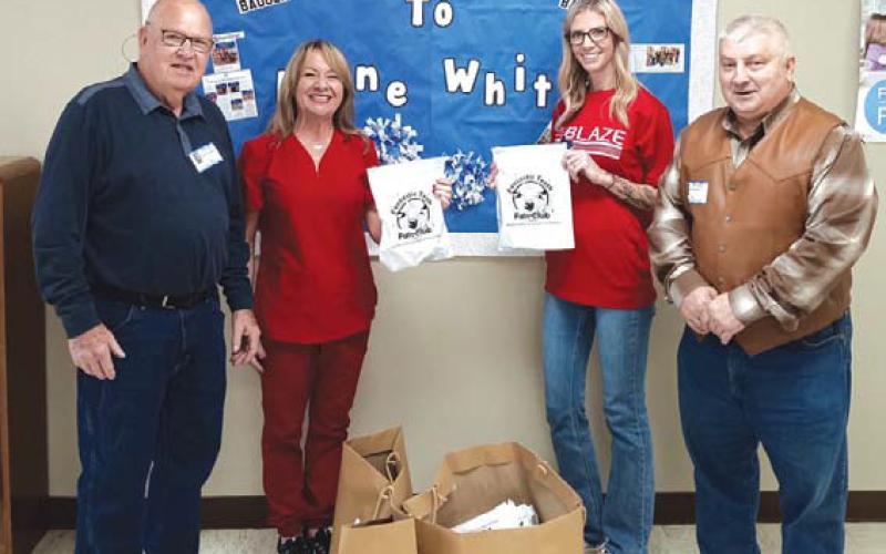 Saratoga Masonic Lodge #546 representatives Bob Caughron, at left, and Paul Plourde were at Kline Whitis Elementary School to donate “Fantastic Teeth Fan Club” dental kits for distribution to first-graders at the campus. Accepting the donation are Dana Tatum and Lori Fry. courtesy photo
