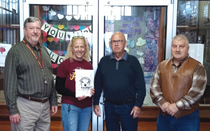 Saratoga Masonic Lodge #546 representatives Bob Caughron and Paul Plourde, both at right, present dental kits to Kenneth Frazier and BJ Bennett for distribution to Lometa students. Courtesy photo
