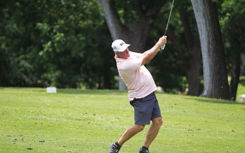 Scott Haverly hits a shot from the fairway on hole fiveduring last year’s A.C. January Memorial Golf Tournament. FILE PHOTO