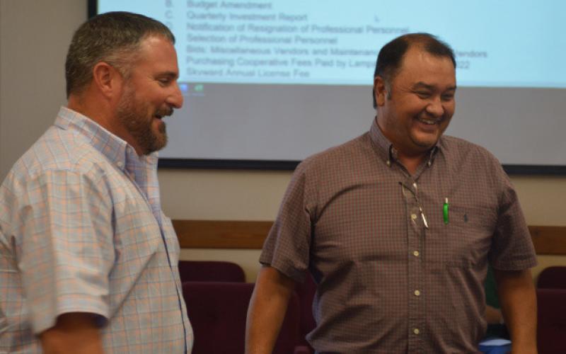 Harvey Stinnett, right, and Jeff Rutland share a laugh after a swearing-in ceremony during Monday’s regular meeting of the school board. Stinnett is new to the board, and Rutland was uncontested for re-election to his trustee position.MONIQUE BRAND | DISPATCH RECORD