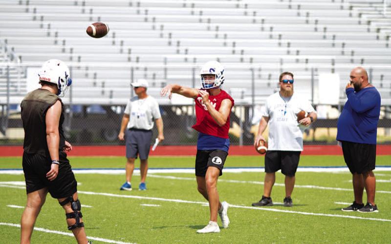 HUNTER KING | DISPATCH RECORD Bryson Roberts releases a pass during the first day of practice on Monday.