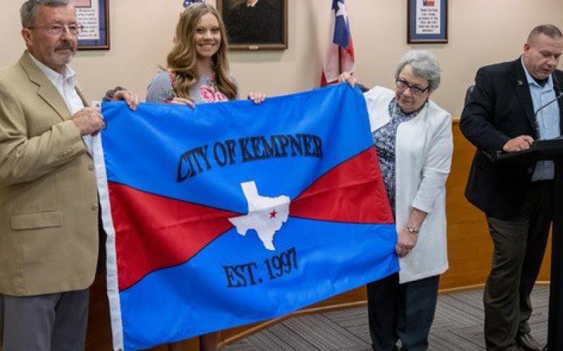 CHRIS MILES | DISPATCH RECORDGene Isenhour, Hayleigh Talasek and former mayor Carolyn Crane hold the new Kempner City Flag as Mayor Wilkerson reads the decree establishing the flag.