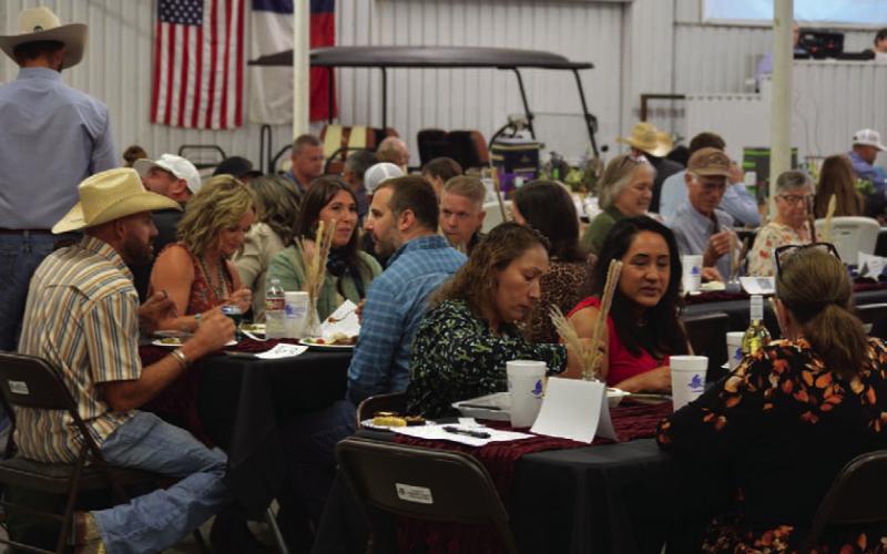 Reverse Raffle attendees gathered inside the show barn for dinner before live auction festivities got underway. ERICK MITCHELL| DISPATCH RECORD