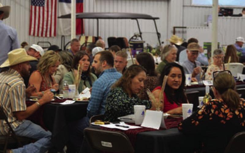 Reverse Raffle guests enjoy dinner inside the show barn during Saturday’s event. ERICK MITCHELL| DISPATCH RECORD