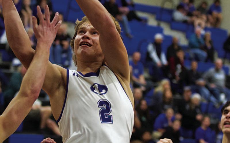 Haegan Oncken goes up between Jarrell defenders for a layup. HUNTER KING | DISPATCH RECORD
