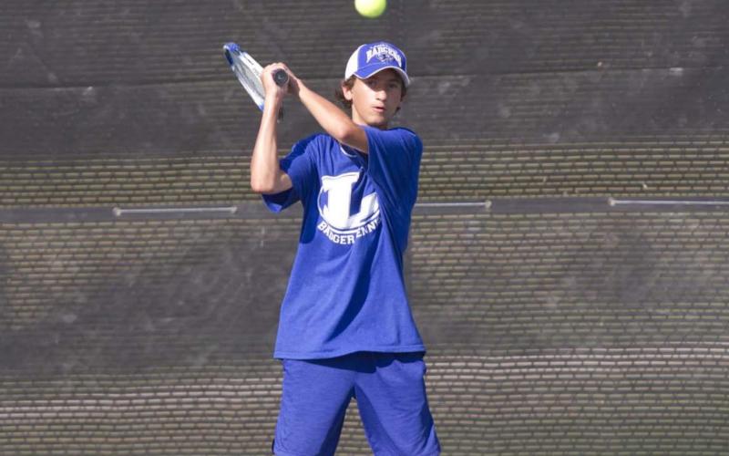 Tyler Ecker hits a backhand shot during a recent match against Ellison before district play begins on Saturday. HUNTER KING | DISPATCH RECORD