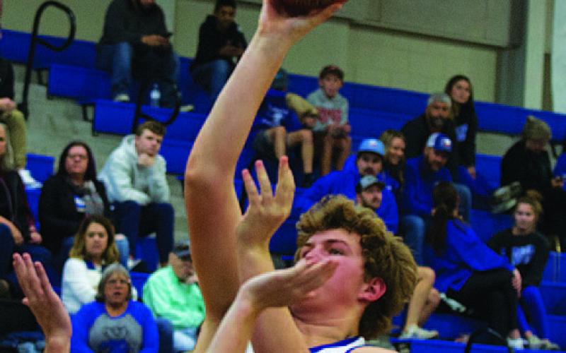 Beau Patterson rises up over defenders for two points. HUNTER KING | DISPATCH RECORD