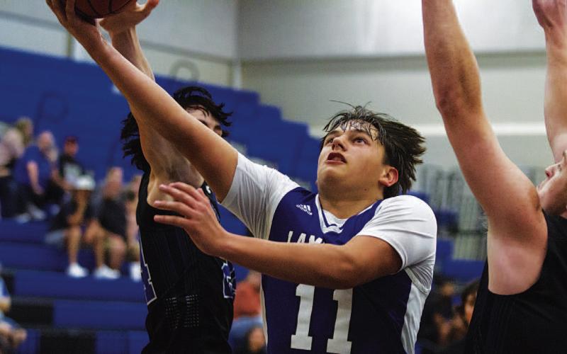 Dylan Polmanteer cuts through two Richland Springs defenders for a layup. HUNTER KING | DISPATCH RECORD