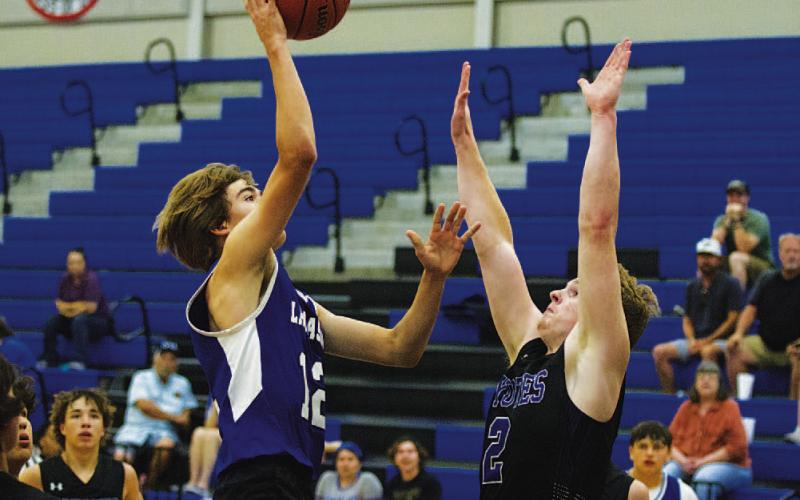 HUNTER KING | DISPATCH RECORD Jax Pratus floats a shot from the paint during Tuesday’s first game.