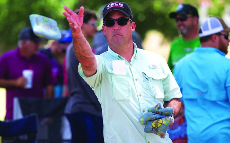 HUNTER KING | DISPATCH RECORD Evan Stubbs tosses a bag early in the cornhole tournament.