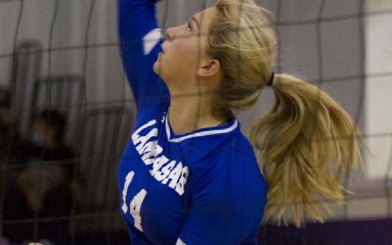 Madison Roedler goes up for a spike during the Lady Badgers’ match against Florence. HUNTER KING | DISPATCH RECORD