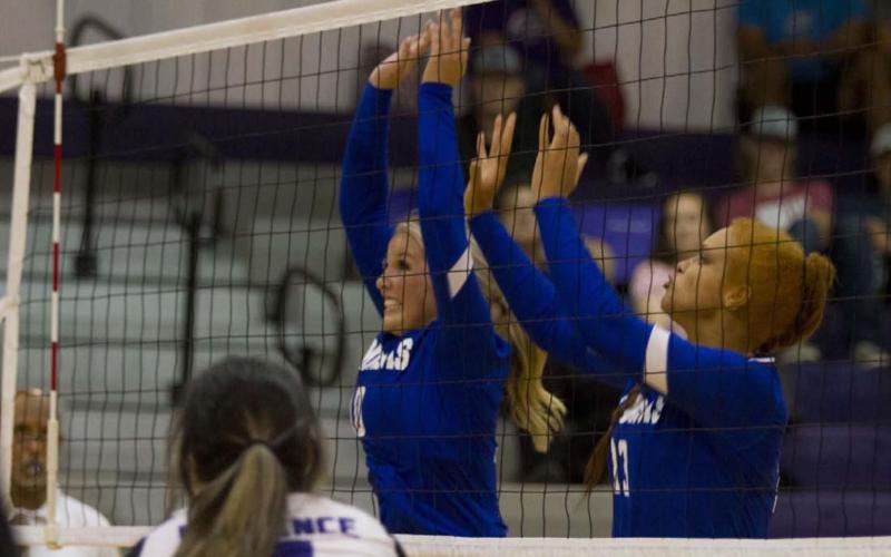 Laurcy Bender and Juliana Dwamena go up for a block as they compete against the Lady Buffs. HUNTER KING | DISPATCH RECORD
