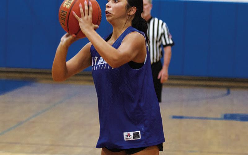 Johnnie Lewis shoots a three during Monday’s games. HUNTER KING | DISPATCH RECORD