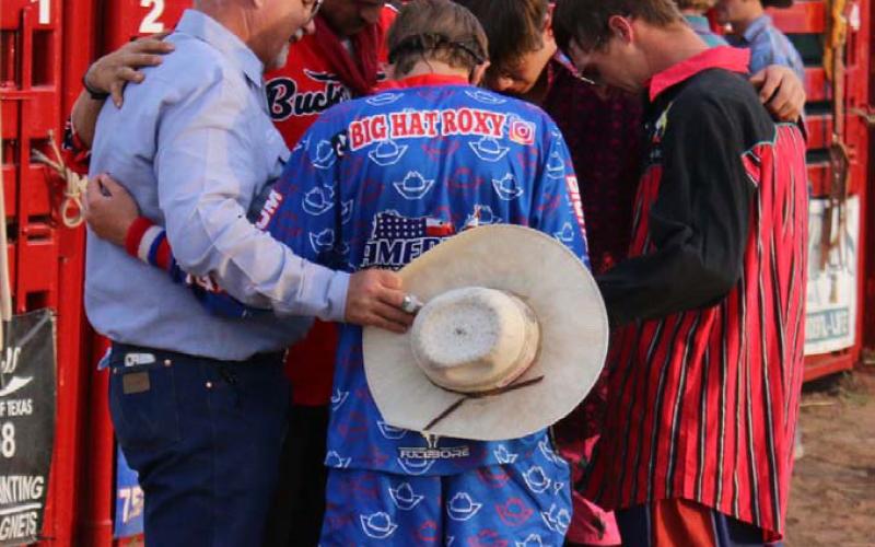 MASON HINES | DISPATCH RECORD Bullfighters for Saturday’s Diamondback Jubilee Rodeo join for a quick prayer prior to the first event.