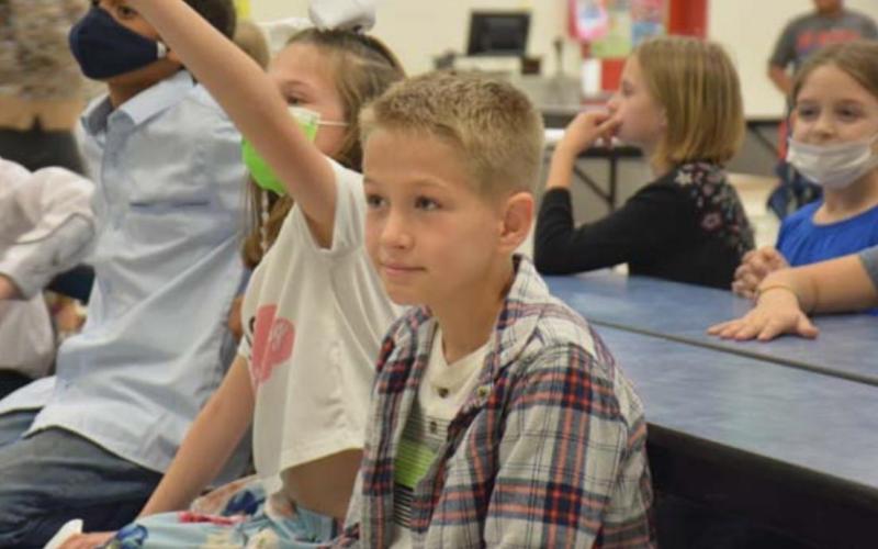Hunter Ingram, 9, was part of the clean-up crew. He listens to directions given by his third-grade teacher. MONIQUE BRAND | DISPATCH RECORD