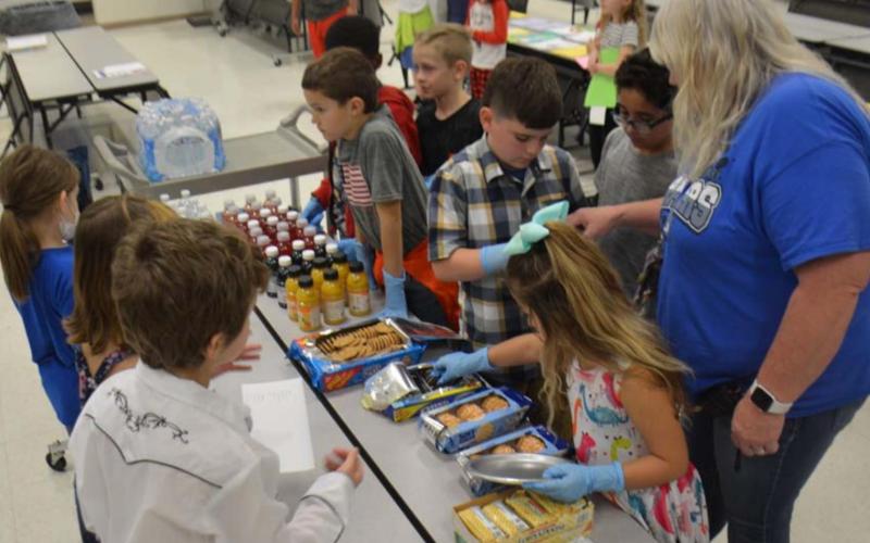 The “cooks” prep the food while the “waitstaff” awaits. MONIQUE BRAND | DISPATCH RECORD