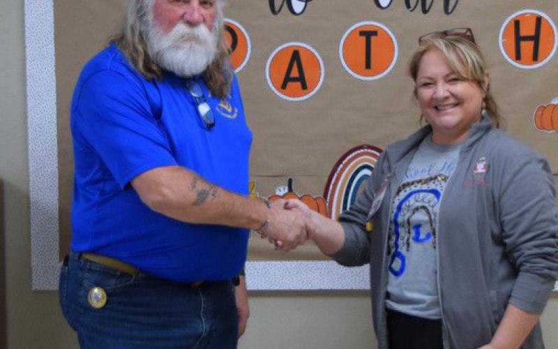 Guy Niles, representing Saratoga Lodge #546, is shown with Dana Tatum, LVN, who accepted dental kits for first-graders at Kline Whitis Elementary School. courtesy photo | Dorton Q. Matthews