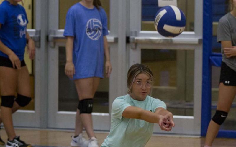 Lilee Hamill bends down for a pass during volleyball practice on Tuesday at the Lampasas High School gym. HUNTER KING | DISPATCH RECORD