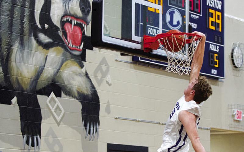 Beau Patterson throws down a dunk in the third quarter against Lago Vista. HUNTER KING | DISPATCH RECORD
