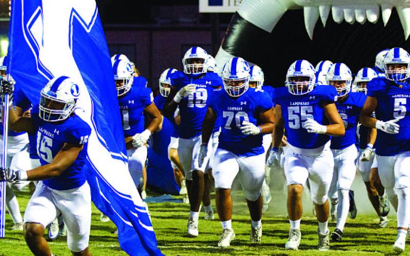 HUNTER KING | DISPATCH RECORD Every week, Dailin Fagan leads the Badgers out with the flag before the game.