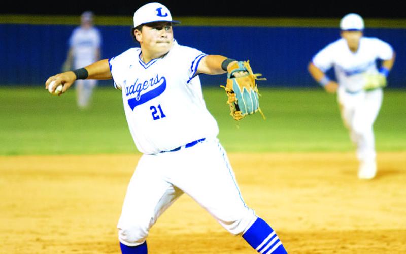 Benny Rodriguez throws home to get a Lago Vista runner out late in Tuesday’s game. HUNTER KING | DISPATCH RECORD