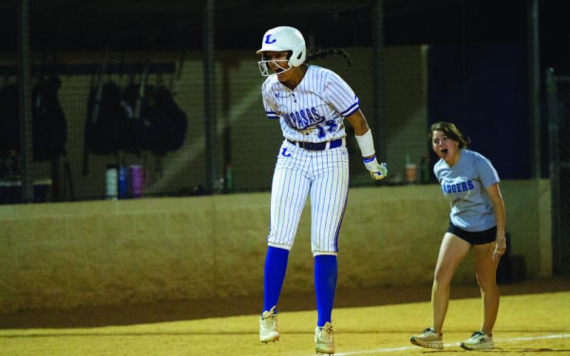 HUNTER KING | DISPATCH RECORD Magilke and coach Blakeli Brookreson scream as she heads toward home plate.