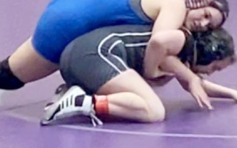 Lady Badger senior Mia Martell, left, placed third at the regional wrestling tournament in the 165-pound weight class on Saturday to qualify for state. LAURA MARTELL | COURTESY PHOTO