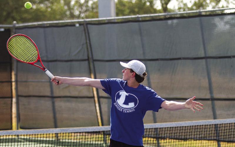 Elijah Copeland reaches for a backhand shot at Tuesday’s match against Leander Glenn. HUNTER KING | DISPATCH RECORD