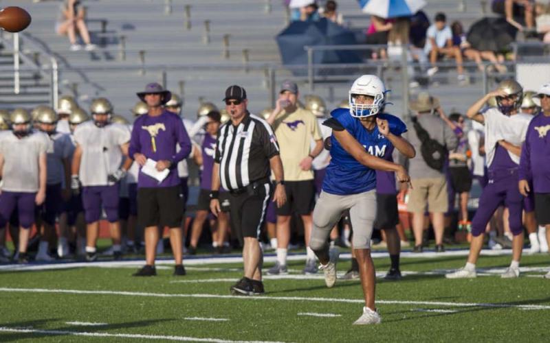 Dylan Sanchez throws a ball down field during the first scrimmage for the Badgers on Friday. HUNTER KING | DISPATCH RECORD