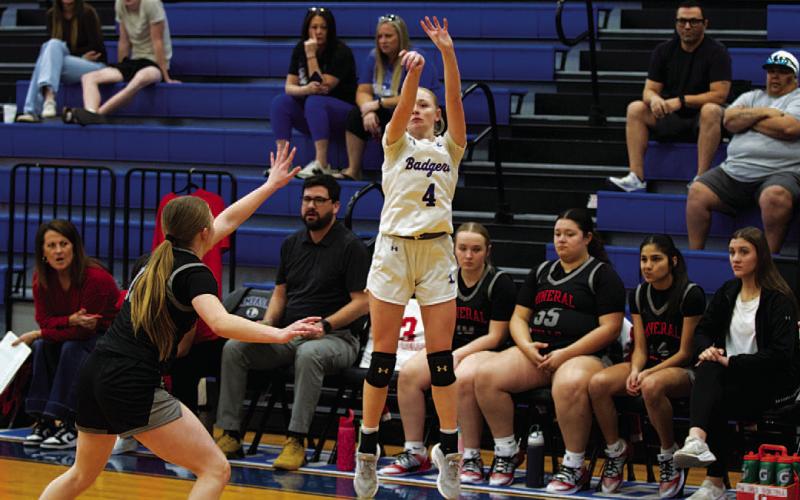 Adalya White shoots a three-point shot in an earlier game this season. HUNTER KING | DISPATCH RECORD