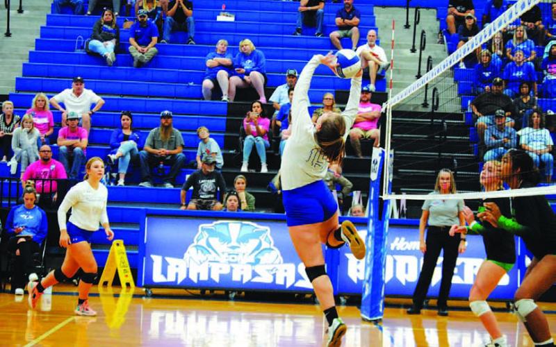 Ava Dowdy flips the ball over the net for a point against Burnet last Friday. HUNTER KING | DISPATCH RECORD