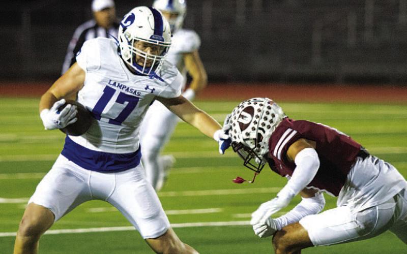 HUNTER KING | DISPATCH RECORD Preston Isom stiff-arms the defender after one of his catches last Friday night.