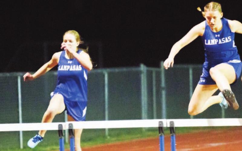 Delanie Smith, right, won the JV girls’ 300-meter hurdles last week at the Johnny “Lam” Jones Relays. Sarah Rouss, left, placed second in this race and won gold in high jump. JEFF LOWE | DISPATCH RECORD