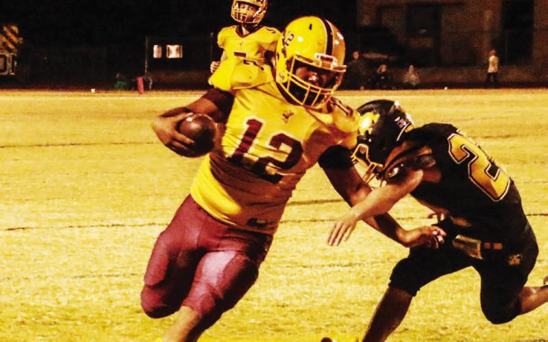 Emmanuel Prado (12) runs the ball after catching a pass during Friday’s win. MEGAN LUSTY | COURTESY PHOTO
