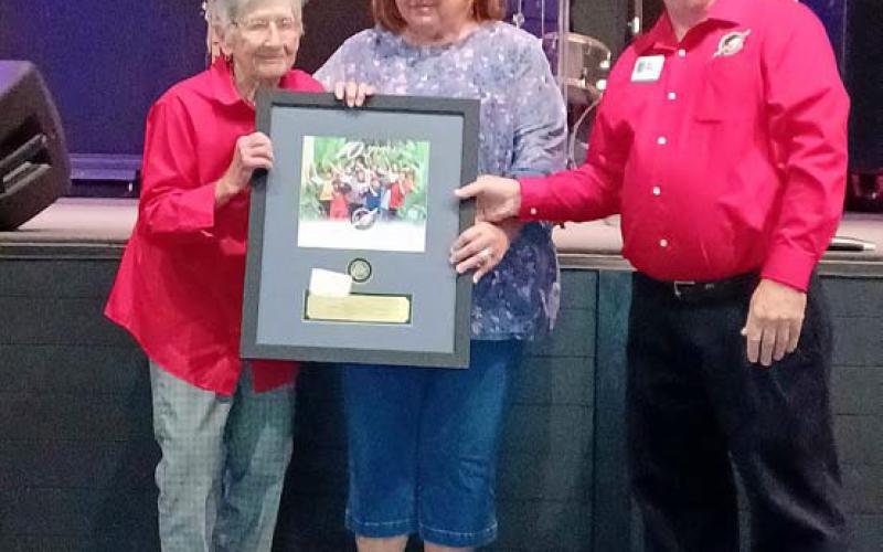 COURTESY PHOTO Receiving recognition from Area Coordinator Kirk Bailey of the Mid-TX Area for her 10 years of service as a drop-off leader at Church of the Hills Annex in Lometa is Margaret Williams, at left. She is accompanied by her daughter, Brenda Faubion. Operation Christmas Child is a project of Samaritan’s Purse that collects packed shoebox gifts for delivery to needy children around the world.