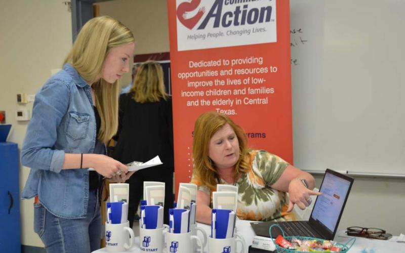 Twenty-year-old Marlee Hyatt, left, goes over employment information with Hill Country Community Action HR Specialist Regina Baker at the Lampasas Economic Development Corp. job fair Thursday. MONIQUE BRAND | DISPATCH RECORD