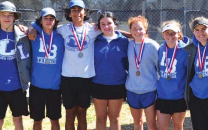 The tennis players pose for a photo with their medals after competing at district. COURTESY PHOTO