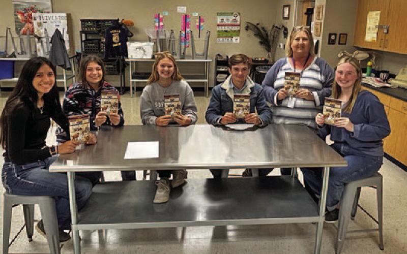 Judy Hail, standing at right, and some of her students display the “Hank the Cowdog” books given to the LISD agriscience program. COURTESY PHOTO