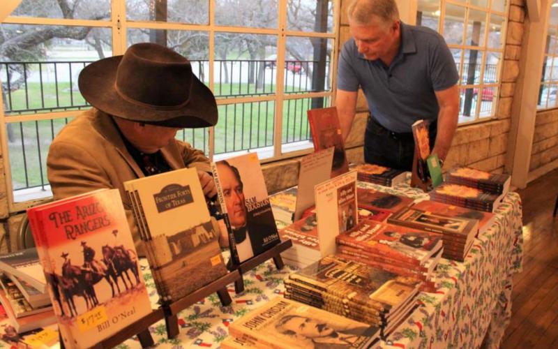 Historian Bill O’Neal, at left, is shown at a March 2020 Daughters of the Republic of Texas event at the Hostess House during which he signed books and spoke on the Texas Rangers in film. O’Neal will return to Lampasas March 7 for a presentation on World War II hero Audio Murphy. FILE PHOTO
