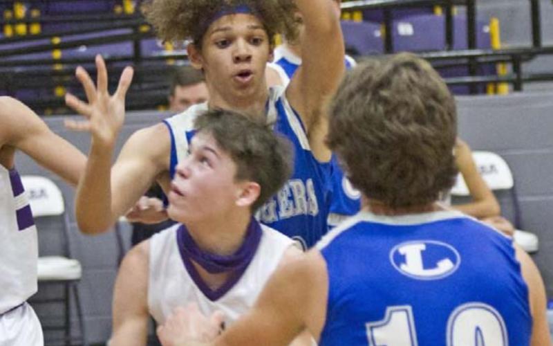 Cameron Stokes (back-center) and Aden Rascoe (10) defend in the Badger JV game at San Saba. JEFF LOWE | DISPATCH RECORD