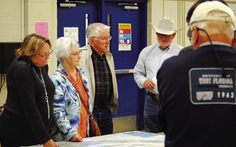 The Texas Department of Transportation offered maps at a recent public meeting showing various options for a possible route around the downtown Lampasas area that could help relieve traffic through the center portion of town. Shown here reviewing the proposals are, from left, Jani Edwards, Wanda Lang, Roland Lang and Mickey Edwards. The deadline to offer input on the relief route alternatives is Dec. 9. HUNTER KING | DISPATCH RECORD