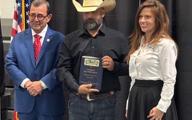 Alex Witherspoon of the Lometa Volunteer Fire Department accepts the Responder of the Year plaque presented by the Hill Country 100 Club. Shown with him is State Sen. Pete Flores. SHARON WATSON | COURTESY PHOTO