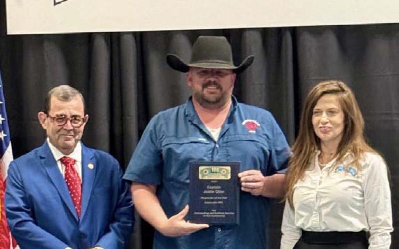 Capt. Daune Sweet holds his plaque, presented by the Hill Country 100 Club recognizing him as the Responder of the Year for the Adamsville Volunteer Fire Department. State Sen. Pete Flores, left, was at the banquet to help honor first responders and their agencies. SHARON WATSON | COURTESY PHOTO