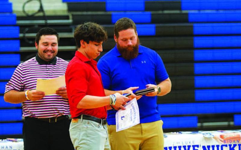 Ethan Moreno looks at his Defensive MVP award. HUNTER KING | DISPATCH RECORD