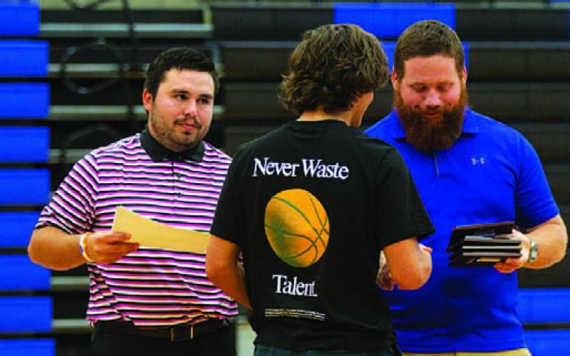 AJ Rosales receives his award from Jaden Napolez, left, and Chance Cottle. HUNTER KING | DISPATCH RECORD
