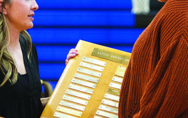 Wooten, left, and Lovejoy talk as the senior receives her award. HUNTER KING | DISPATCH RECORD
