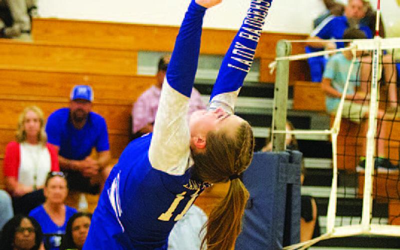 HUNTER KING | DISPATCH RECORD Ava Dowdy sets to Lilee Hamill in the match against Shoemaker.
